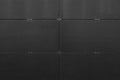 Black uneven surface of building wall with bracketed tiles Royalty Free Stock Photo