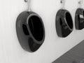 Black urinals in men public toilet. Modern ceramic urinals hanging on the tiled wall. 3d rendering illustration