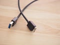 Black USB cable with usb3 connector on board wood with high-speed data transfer concept