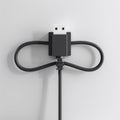 Black usb cable loop detail in minimalist design concept on light background Royalty Free Stock Photo