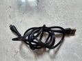 black USB cable roll on patterned marble floor Royalty Free Stock Photo