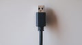 A black usb cable on a white background symbolizes simplicity in cord organization Royalty Free Stock Photo