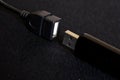 A black USB device, a flash drive or card reader and an OTG adapter are on a dark background. Diagonal Royalty Free Stock Photo