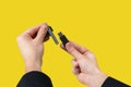 Black USB Flash drive on hand with isolated yellow background Royalty Free Stock Photo