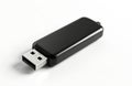 Black USB flash drive on white background. Portable storage device for data transfer and backup. Modern tech accessory for Royalty Free Stock Photo