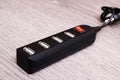 Black USB hub on a wooden background Royalty Free Stock Photo