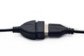 Black usb type-A male and female cable on a white background with a symbol in one of the connections, you can see part of the