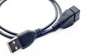 Black usb type-A male and female cable on a white background with a symbol in one of the connections, you can see part of the