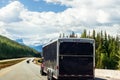 Black van camping car on highway sunny cloudy sky background. Camper on the road. Royalty Free Stock Photo