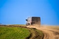 Black van driving through a dirt hill in a green field Royalty Free Stock Photo