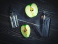 Black vaporizer in the smoke with sliced apple Royalty Free Stock Photo