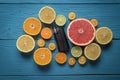 Black vaporizer surrounded by citrus