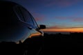 Black vehicle car with reflection of landscape sunset