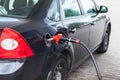 Black vehicle refueling with petrol