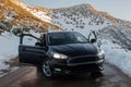 Black vehicle standing on winter road