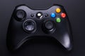 Black video game controller, joystick for game console isolated on black background Royalty Free Stock Photo