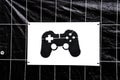 Black video game controller sign on white background on the wall Royalty Free Stock Photo