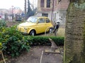 Vintage bicycle near the small old car