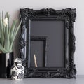 Black vintage ornate frame in classic style. Dark gothic royal frame in the room. Royalty Free Stock Photo