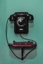 Black vintage phone hanging on the wall Royalty Free Stock Photo