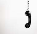 Black vintage telephone handset on white background