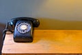 Black vintage telephone on wood desk Royalty Free Stock Photo