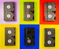 Black vintage VHS videotapes on red, blue, yellow, pink background. Plastic retro video cassettes with analog magnetic