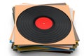 Black vinyl LP record with heap of covers isolated on white background. Royalty Free Stock Photo