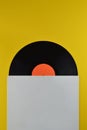 Black vinyl record halfway out of white cover Royalty Free Stock Photo