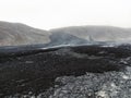 Black volcanic lava rock spread across the valley near Geldingadalir active Volcano