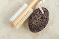 Black volcanic pumice stone and massage foot brush with white pumice stone. Natural spa, pedicure and foot calluses removal. Royalty Free Stock Photo