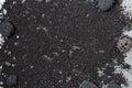 Black volcanic sand background with lava rocks