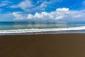 Black volcanic sand beach in Bali Island Indonesia