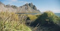 Black volcanic sand beach dunes in Stokksnes Vestrahorn mountain in the background Nature and ecology concept background