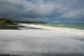 Black volcanic beach with ocean water foam, Hawke`s Bay, Napier, North Island, New Zealand