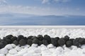 Black volcanic stones over white. Decoration detail at Santorini island Royalty Free Stock Photo