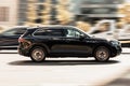 black Volkswagen Touareg CR car on the city road in motion. Fast moving car on the street. SUV driving along the highway in city Royalty Free Stock Photo