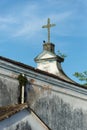 A black vulture standing beneath the cross of an old church. Abandoned place