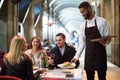 Black waiter serving table on the terrace Royalty Free Stock Photo