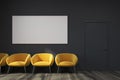 Black waiting room, yellow chairs, poster