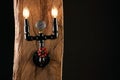 Black wall lamp made of water pipes Royalty Free Stock Photo