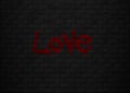 Black wall surface with love graffitti in dark bricks. Romantic lover text in wall texture in abstract. Royalty Free Stock Photo