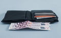 Black wallet and 500 euro bills on gray. Royalty Free Stock Photo