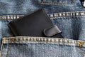 Black wallet in jeans trousers back pocket