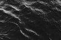 Black water surface with waves. Water ripples. Texture of the water surface Royalty Free Stock Photo