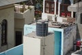 Black water tanks of industrial building on roof top or deck of an old residential building in a rural area. Plastic water tanks