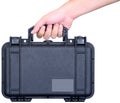 Black watertight suitcase in hand Royalty Free Stock Photo