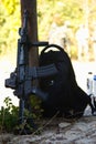 black weapon in the shadow next to a black backpack, airsoft Royalty Free Stock Photo