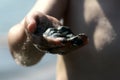 Black wet sand in child right hand