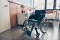 black wheel chair in the empty room ward of the hospital. Close up photo, bed is on the background, white doors medicine Royalty Free Stock Photo